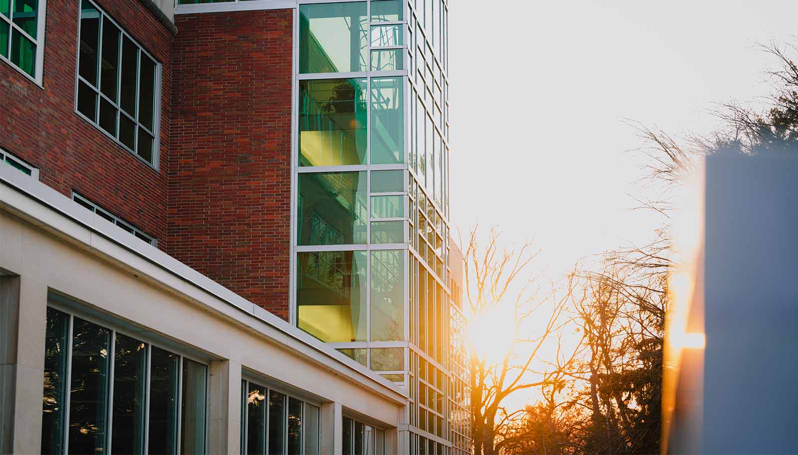 The sun sets on a campus building.